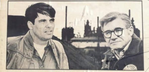 A young "Oil Can" Eddie Sadlowski on the left looking off into the distance with Jim Balanoff on the right staring at the camera with a steel mill in the background.