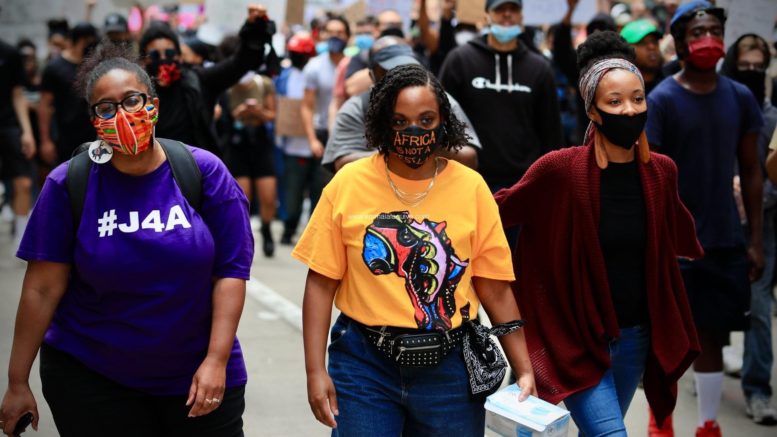 Pa. State Rep. Summer Lee (center) marches in downtown Pittsburgh In late May (Emmai Alaquiva). Photo from PayDayReport.com